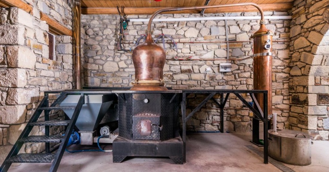 Traditional copper raki still inside a stone room